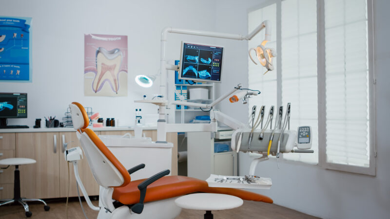 Interior of modern equipment oral office with teeth x ray on monitors, stomatology dentistry orthodontist medical clinic . Zoom in shoot. Hospital cabinet for dental health, care treatment
