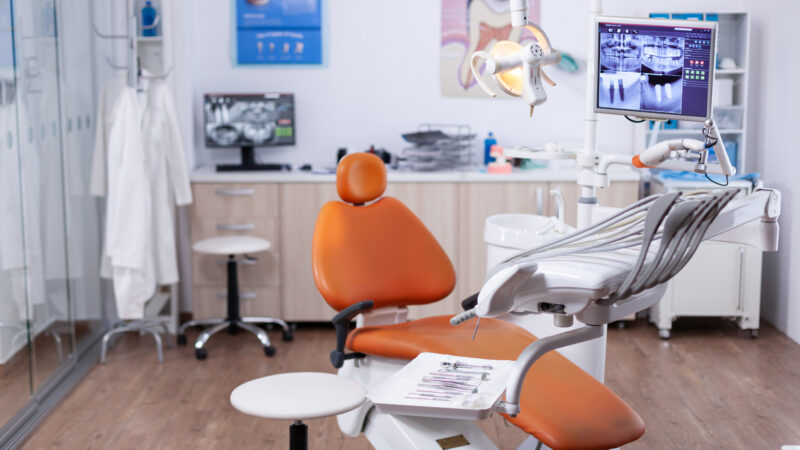 Dentist's office interior with modern chair and special dentisd equipment. The interior of stomatology clinic.